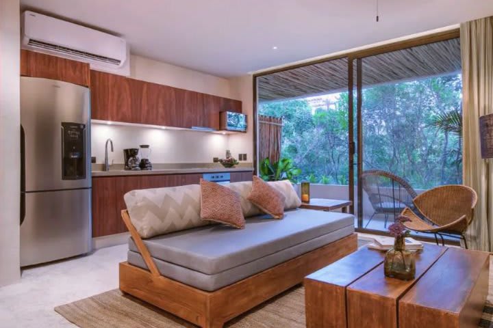 Sitting area and kitchen in a studio with terrace and jungle view