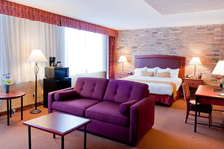 Guest room with a sitting area at the Quality Hotel - Inn at False Creek in Vancouver