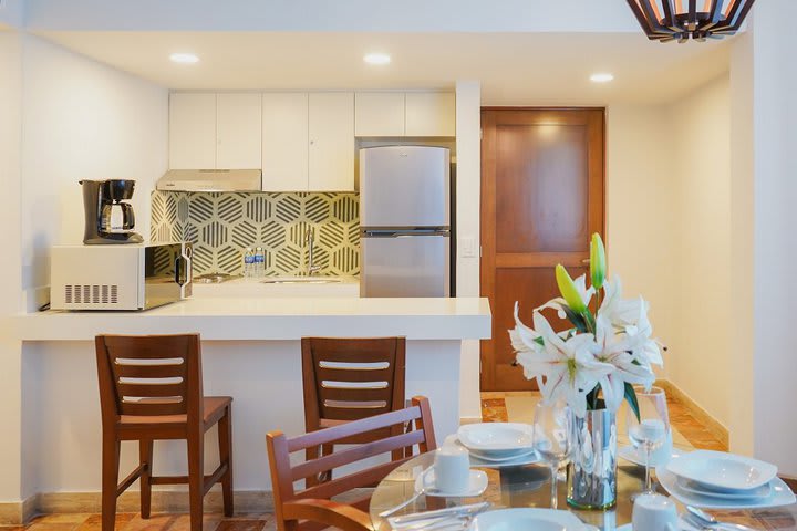 Table and kitchen in a suite